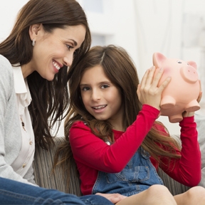 mom and daughter with piggy bank