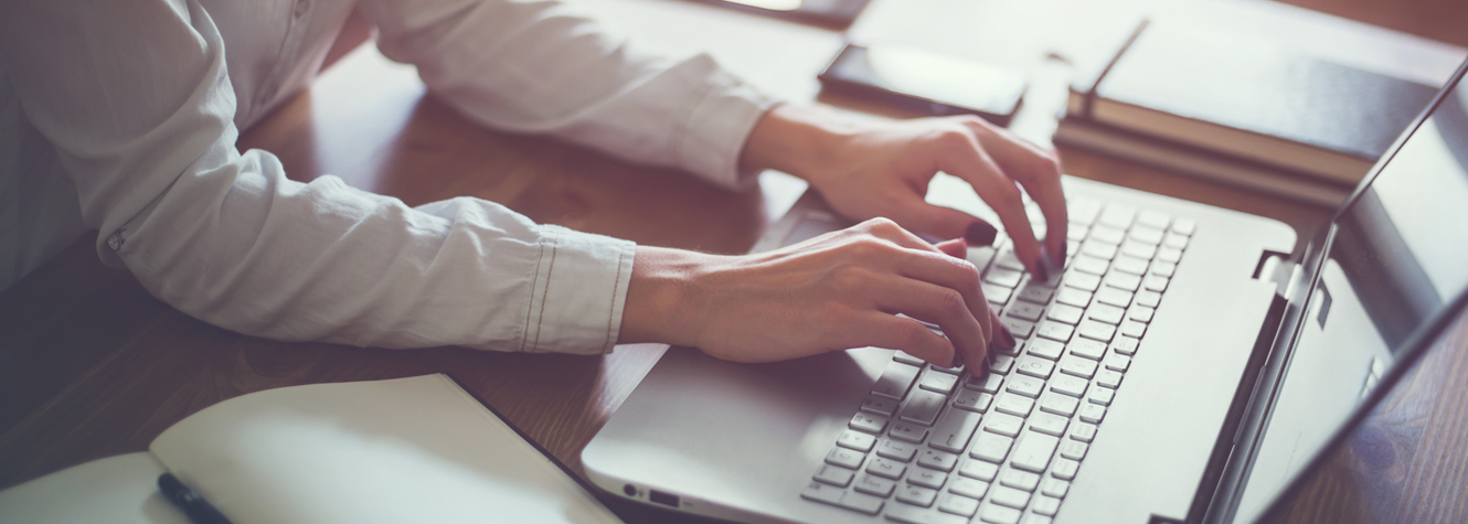 woman typing on laptop