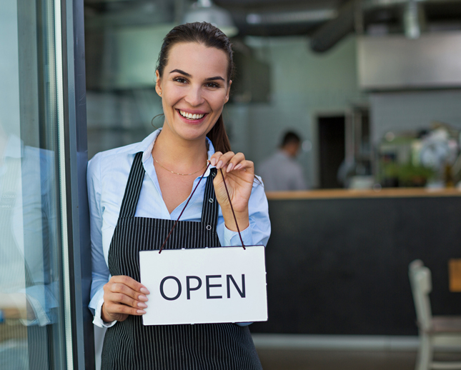 cafe owner with open sign