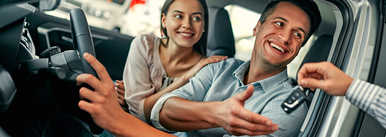 couple getting keys to a new car