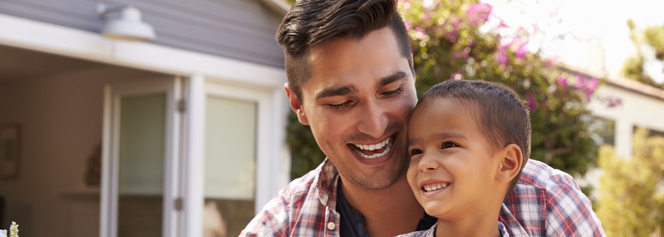 Hispanic father and son in backyard