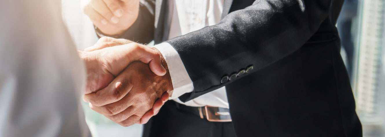 Close up of two hands in a handshake.