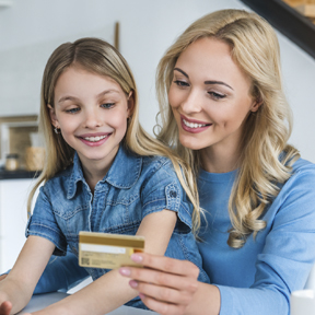 mom and daughter with debit card
