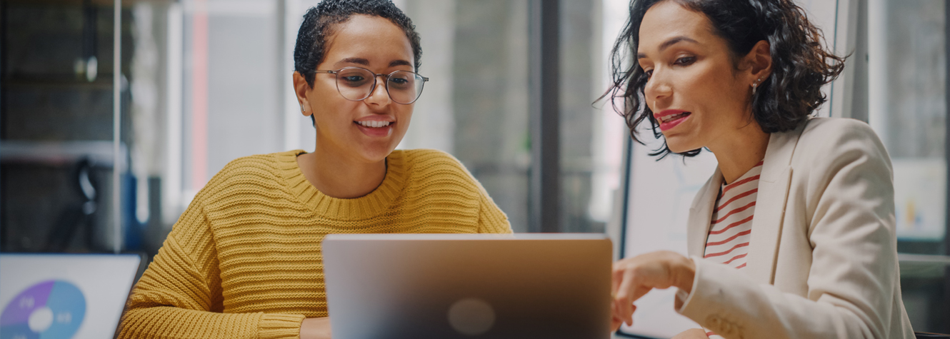 Hispanic business women working on laptop