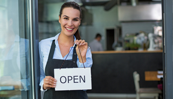 cafe owner with open sign