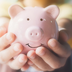 girl holding piggy bank