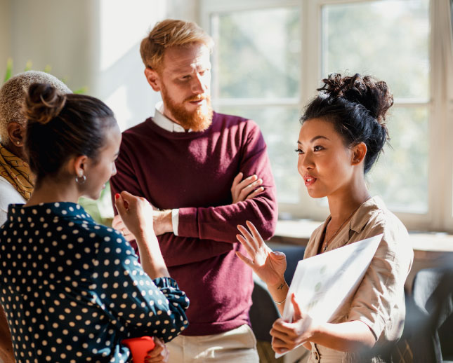 A group of office workers talking.