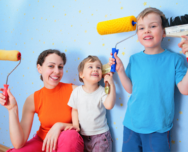 mom and two kids painting