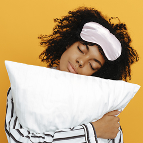 woman with sleeping mask and pillow